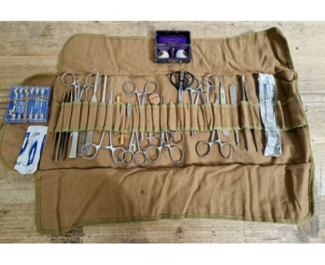 A collection of vintage surgical tools together with a pair of vintage glass eyes in box. 
