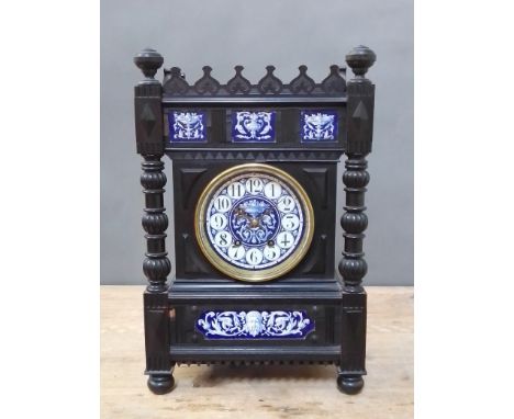 A late 19th century Aesthetic style architectural mantle clock, ebonised with blue and white pottery panels and dial, movemen