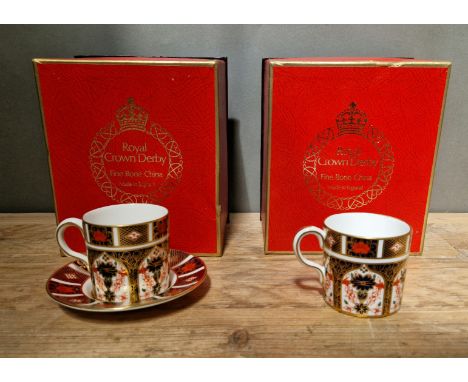 A set of two Royal Crown Derby 1128 Imari coffee cups and one saucer, with boxes. 