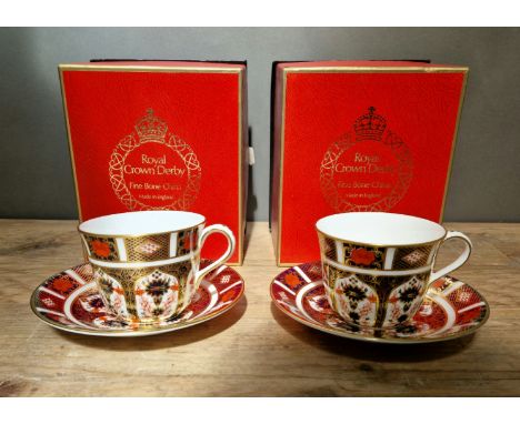 A set of two Royal Crown Derby 1128 Imari teacups and saucers, with boxes. 