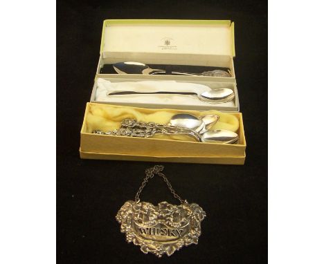 A pierced and chased silver Decanter Label "Whisky" by Francis Howard, a silver commemorative Spoon, another silver Spoon, si