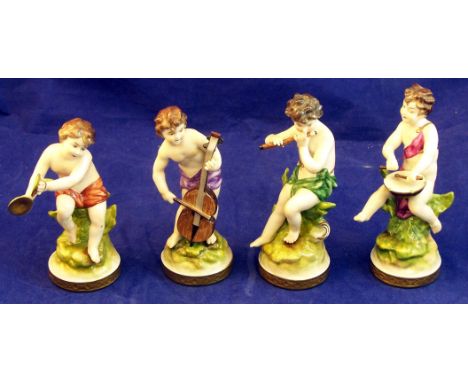 A set of four Rudolstadt Volkstedt Figures of Cherub Musicians on gilt circular bases, 4 1/2" (11cms) high (drum stick broken