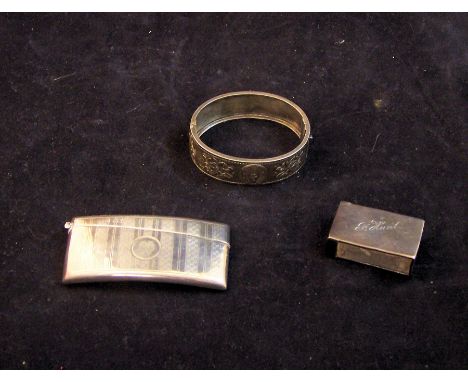 An engraved silver Visiting Card Case with circular cartouche, London 1926; a silver Matchbox Holder, and a silver Bangle.