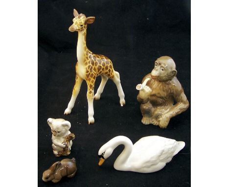 A Beswick Model of a Monkey smoking a pipe no. 1049, a Beswick Giraffe, a Swan and two other items.