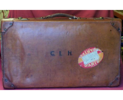 A brown leather vintage Suitcase inscribed with initials, 28" (71cms) wide.