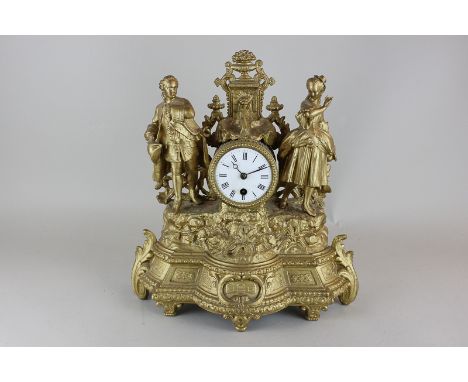 A French reproduction gilt mantle clock, the surround modelled as a man and a woman in 18th century dress in a garden with a 