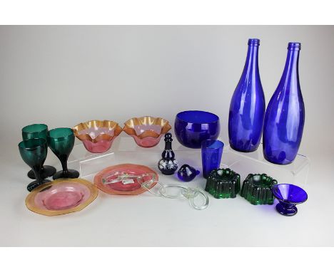 A collection of coloured glass tableware including a blue bowl, pair of green salts and a small enamel decorated blue glass b