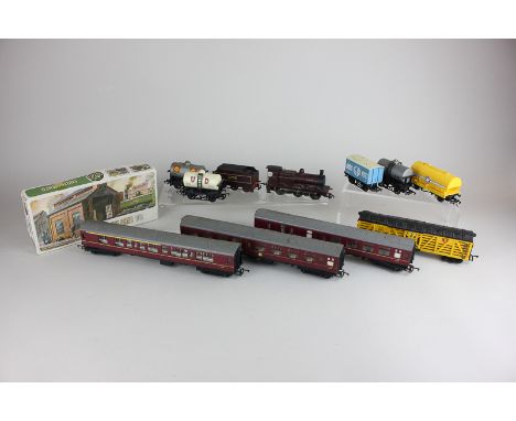 A 00 gauge locomotive and tender in burgundy, together with three British Railway carriages, various tankers and a boxed Airf