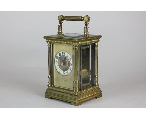 A brass and bevelled glass cased carriage clock, the face with Arabic numerals and gilt surround marked Joseph C Cairns, Port