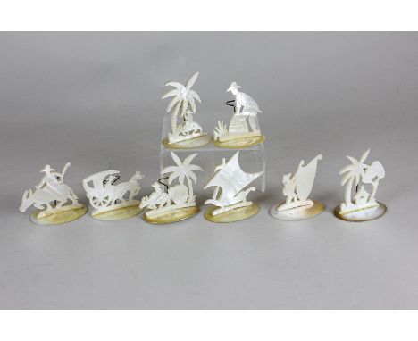 A set of eight Chinese mother of pearl place settings depicting sail boats, figures with animals and dwellings, tallest 7cm h