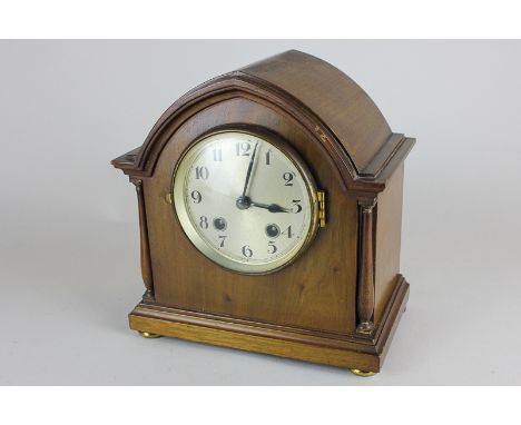 An early 20th century mantle clock, in arched mahogany case, with movement striking and gong