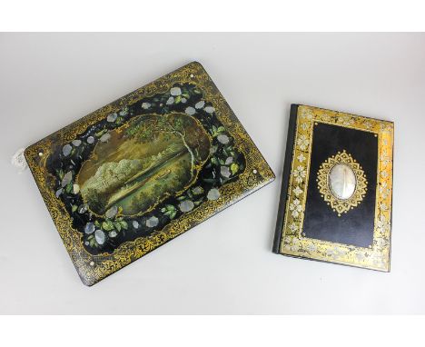 A Victorian black lacquered folder with gilt embellishment and large mother of pearl cabochon, together with a similar artist