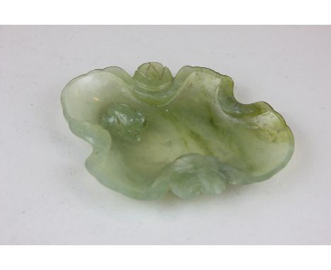 A spinach green jade coloured glass dish in the shape of a frog in a pool, 12cm