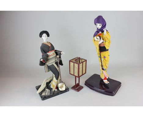 Two Japanese composite dolls on stands in traditional dress, together with a lantern, a mid 20th century Kewpie character pla