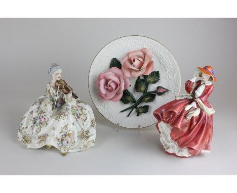 A Royal Doulton Top O' The Hill porcelain figure HN1834, a porcelain figure of a woman in 18th century dress playing the viol