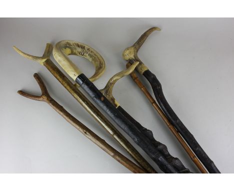 A ram's horn walking stick, three horn handled walking sticks and one other walking stick