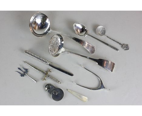 An Edwardian silver sugar tong in the shape of a wishbone, a silver vesta case, teaspoon, butter knife and pickle fork, with 