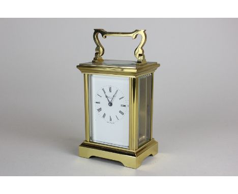 A brass and bevelled glass cased carriage clock, the white enamel face marked Henley, with Roman numerals, 16cm