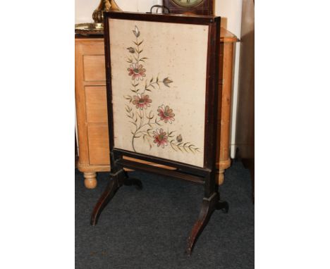 A Victorian mahogany framed fire screen with extending rectangular floral tapestry screens on twin supports, 53cm