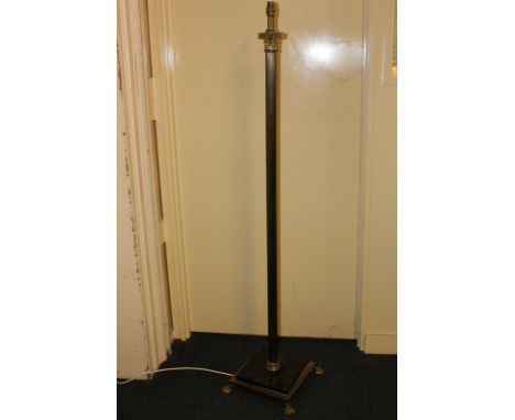 A bras Corinthian column standard lamp on square base with paw feet