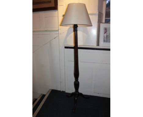 A mahogany standard lamp with facetted baluster stem, on tripod base