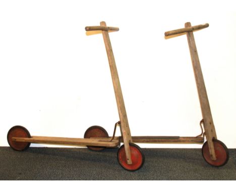 Two vintage wooden scooters.
