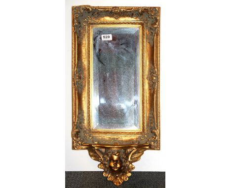 A gilt framed wall mirror with shelf, H. 65cm W. 33cm.