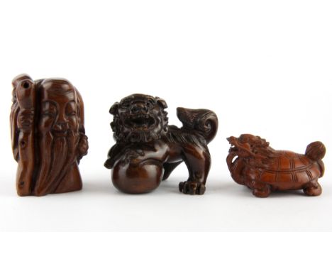 A Carved fruitwood netsuke of a mythical tortoise together with two further carved items.