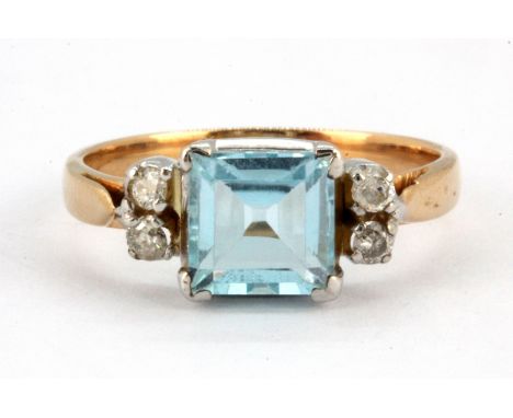 An 18ct yellow gold ring set with a step cut aquamarine and diamonds, (L.5).