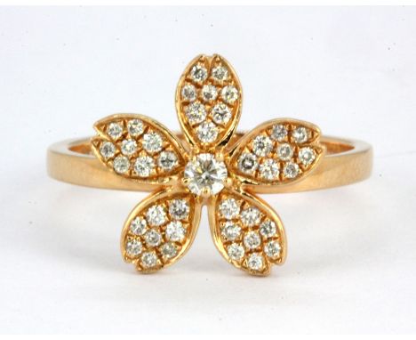 An 18ct rose gold (stamped 18k 750) flower shaped ring set with brilliant cut diamonds, (N).