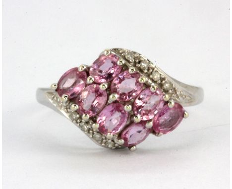 A 9ct white gold ring set with pink sapphires and diamonds, (M).