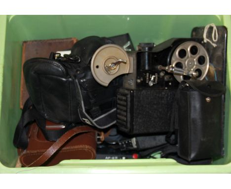 A vintage hand crafted 8mm projector and a group of cameras.