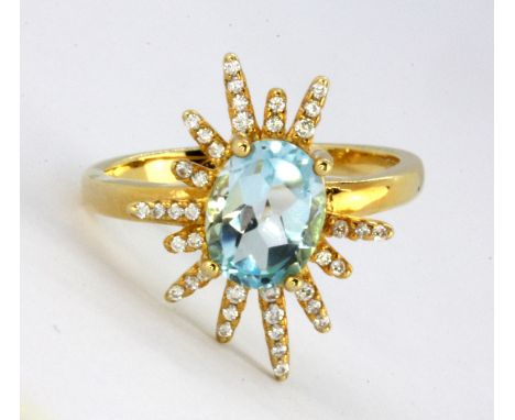 A 925 silver gilt ring set with oval cut Swiss blue topaz and white stones, (R).