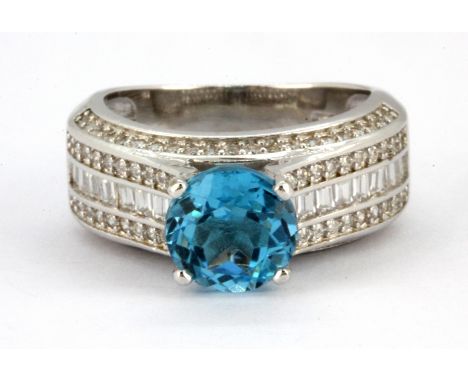A 925 silver ring set with blue topaz and white stones, (N).