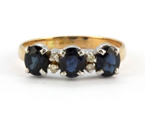 An 18ct yellow and white gold ring set with three oval cut sapphires and diamonds, (L).