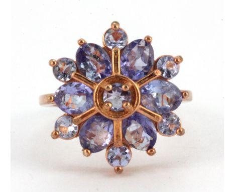 A 925 silver rose gold gilt ring set with round cut tanzanites in the shape of a snowflake, (L.5).