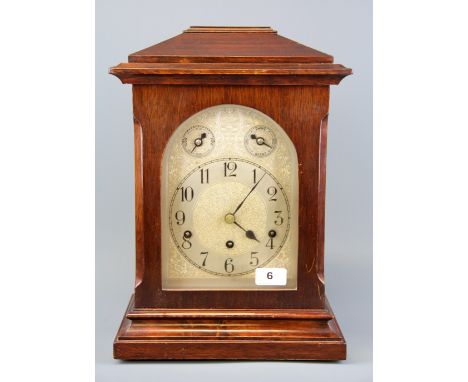 A mahogany veneered chiming mantle clock, H. 36cm.