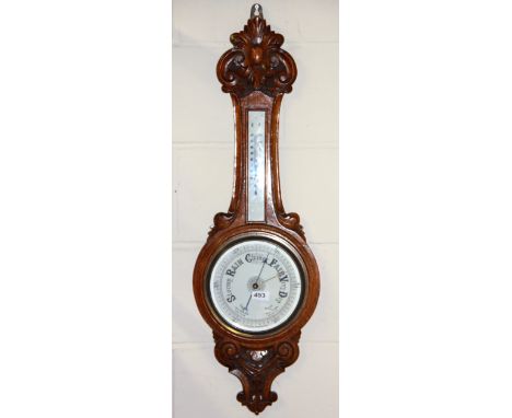 A carved oak banjo barometer, H. 90cm.