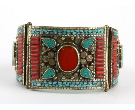 A Tibetan traditional white metal bangle decorated with enamelled mosaic, blue stones and cornelian, Dia. 6cm.
