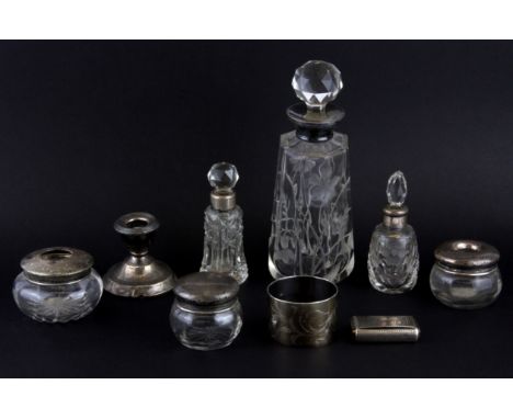 A group of silver topped items, a napkin ring and a snuff box.