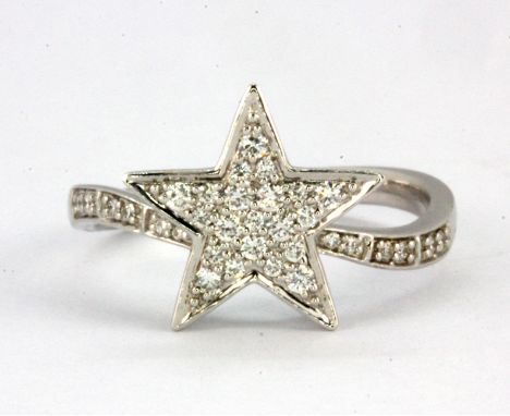 An 18ct white gold star shaped crossover ring set with brilliant cut diamonds, (N).