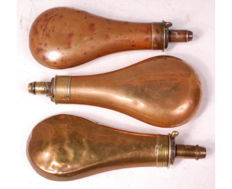 A 19th century copper and brass mounted shot flask, together with two others similar. (3)