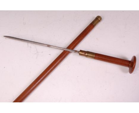 A late 19th century sword stick, the hardwood shaft revealling a 25cm square pointed blade, the brass locking mechanism stamp