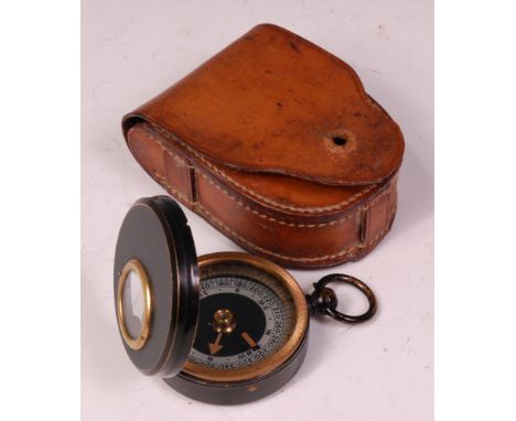 A post WW II military marching compass stamped verso Prov: Pat, in a stitched leather case.