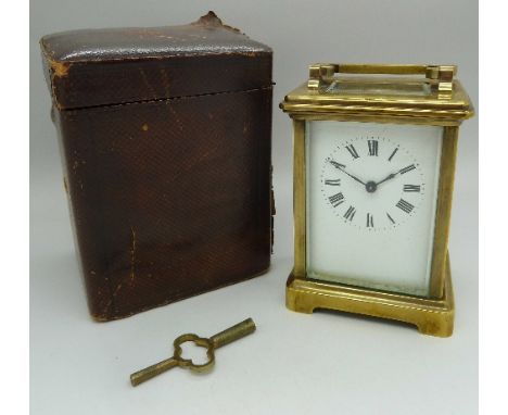 A brass four-glass sided carriage clock with French movement, height 11cm, with outer case 