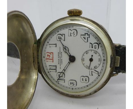 A gentleman's silver half-hunter trench watch with flip-top case, wire lugs, Swiss movement, the dial signed Wolf Bros Cape T