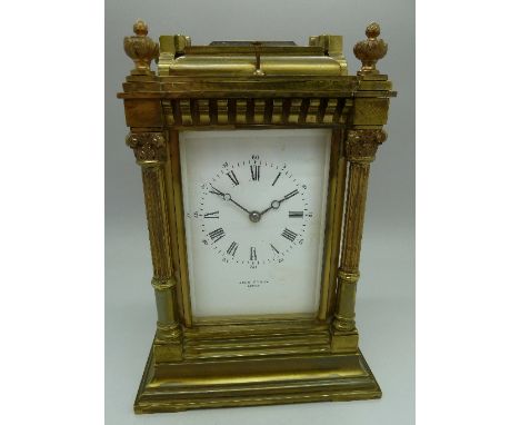 A brass four-glass sided carriage clock, with four corinthium columns, retailed by John Dyson, Leeds. French movement, gong s
