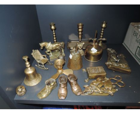 A selection of brass fire side items including candle sticks and terrier dog door knocker