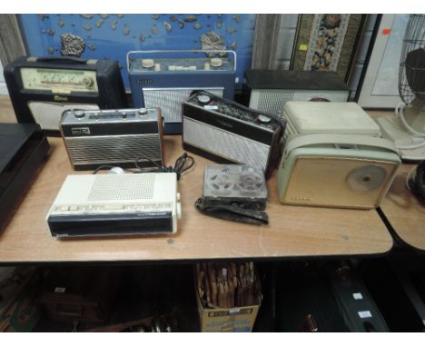 A selection of vintage transistor radios including Hacker Roberts and Hitachi alarm clock