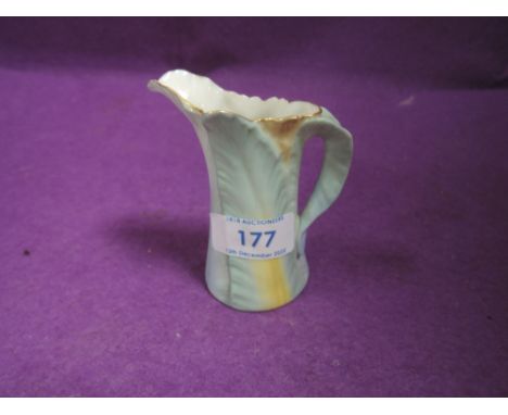 A Royal Worcester creamer having naturalistic design on Green back stamp